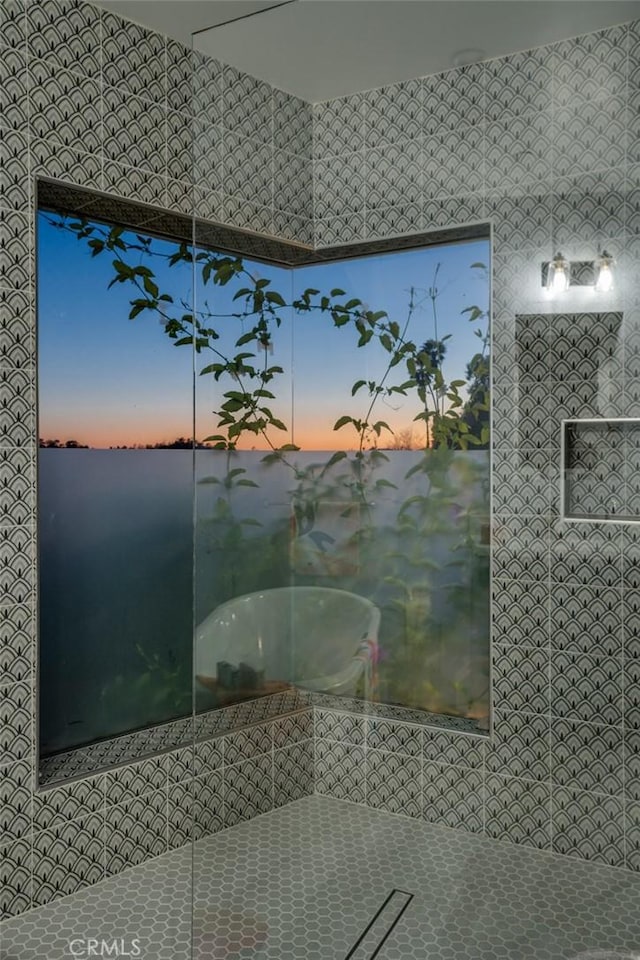 full bathroom featuring tile patterned flooring and walk in shower