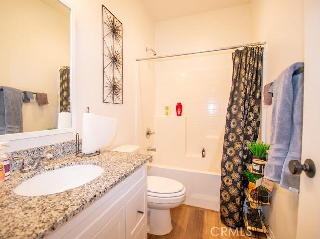 36626 Sevilla Way, Beaumont, CA 92223 - bathroom with vanity, wood finished floors, and shower / tub combo with curtain