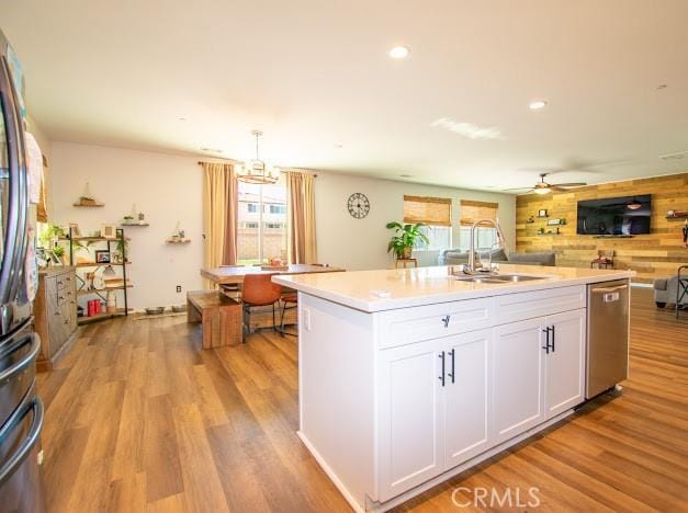 kitchen featuring a sink, light wood-type flooring, plenty of natural light, and appliances with stainless steel finishes
