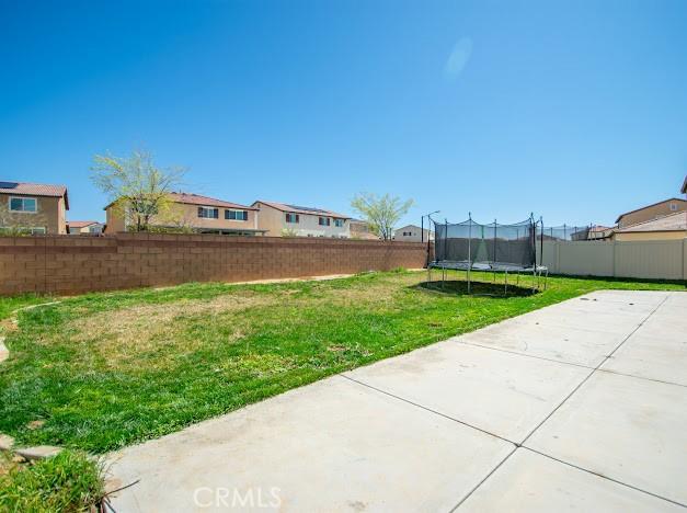 36626 Sevilla Way, Beaumont, CA 92223 - fenced backyard featuring a patio area and a trampoline