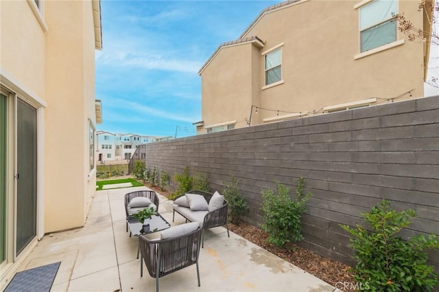 view of patio / terrace featuring an outdoor living space and a fenced backyard