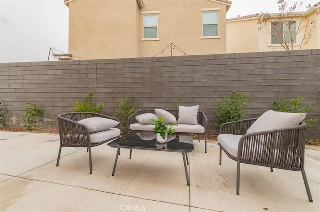 view of patio with an outdoor living space and a fenced backyard