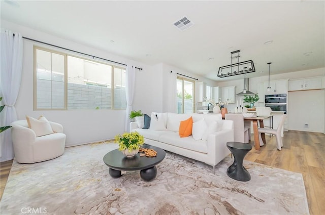 living area with visible vents and light wood finished floors