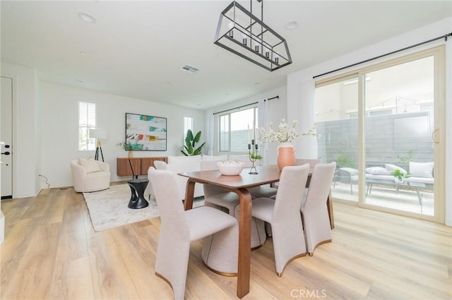 dining room featuring visible vents and light wood-type flooring