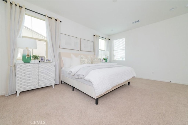 bedroom with visible vents, carpet flooring, and radiator heating unit