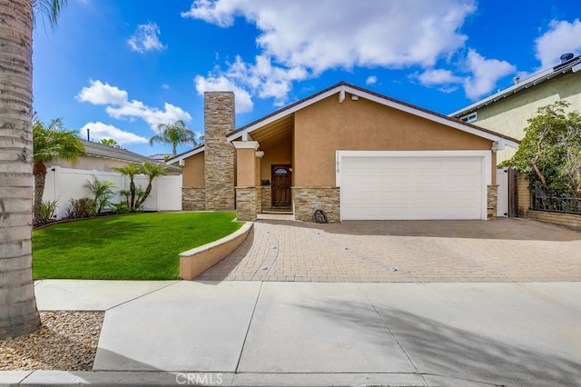 view of front of home with fence, a front yard, stucco siding, a garage, and driveway