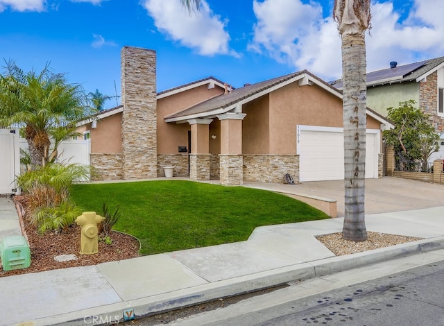 view of front of property with a front lawn, fence, stucco siding, a garage, and driveway