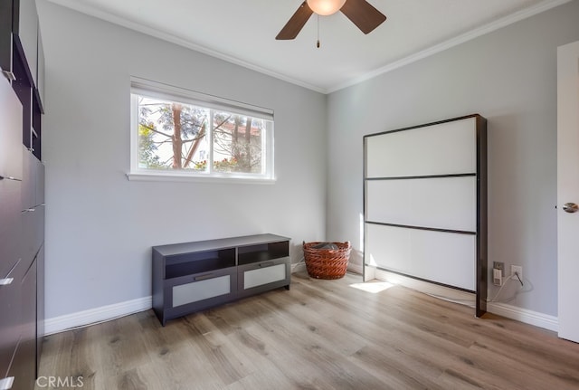 bedroom featuring crown molding, wood finished floors, baseboards, and ceiling fan