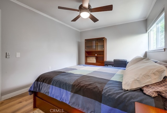 bedroom with crown molding, wood finished floors, baseboards, and ceiling fan