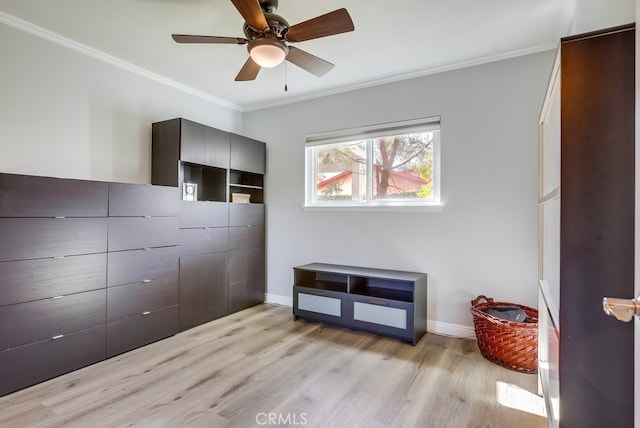 bedroom featuring crown molding, light wood-style flooring, baseboards, and ceiling fan