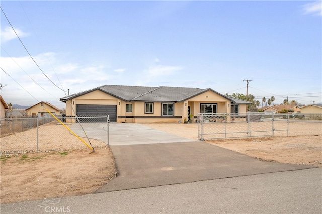 10983 Redwood Ave, Hesperia, CA 92345 - view of front of house with a garage, stucco siding, driveway, and a fenced front yard