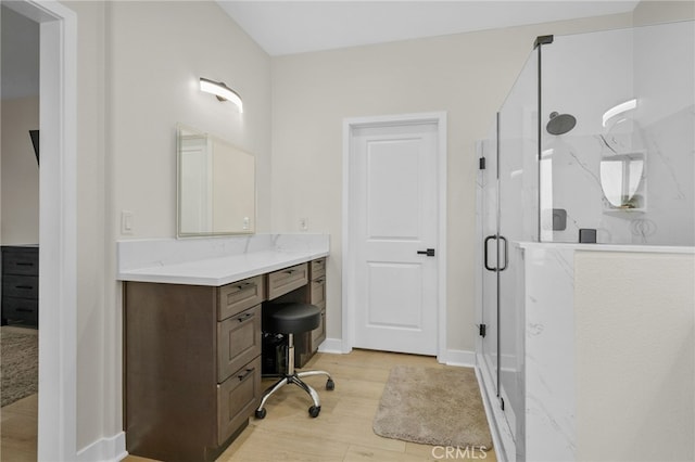 10983 Redwood Ave, Hesperia, CA 92345 - full bath with a shower stall, wood finished floors, vanity, and baseboards