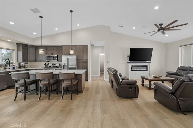 10983 Redwood Ave, Hesperia, CA 92345 - living area featuring lofted ceiling, light wood finished floors, ceiling fan, recessed lighting, and baseboards