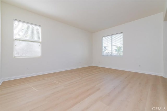 unfurnished room featuring light wood-style flooring and baseboards