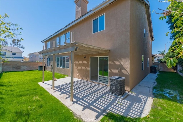 rear view of house featuring a patio, a yard, a pergola, and stucco siding