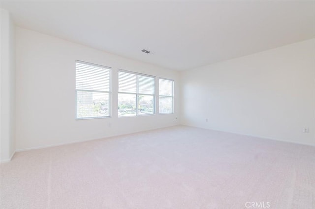 unfurnished room with visible vents and carpet floors