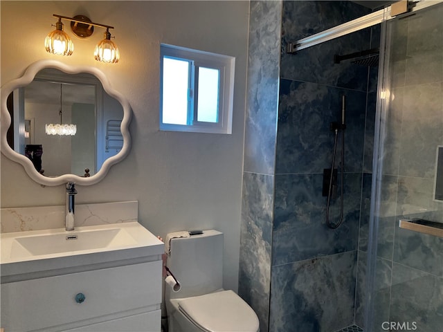 full bathroom featuring a stall shower, toilet, and vanity