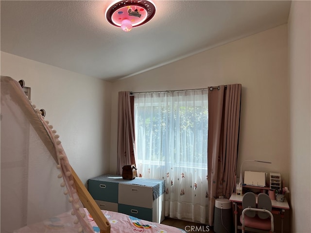 bedroom featuring a textured ceiling and lofted ceiling