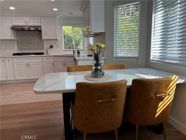 dining space featuring light wood finished floors and recessed lighting