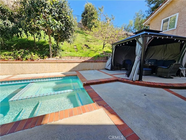 pool featuring a gazebo, a patio area, and an in ground hot tub