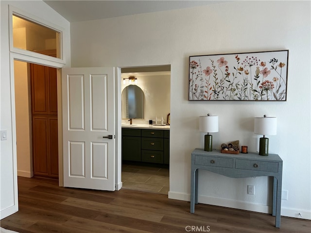 corridor with dark wood-style floors and baseboards