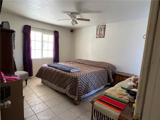 bedroom featuring light tile patterned floors and ceiling fan