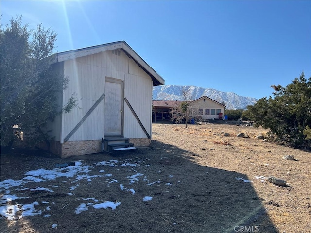 view of outdoor structure featuring a mountain view and entry steps