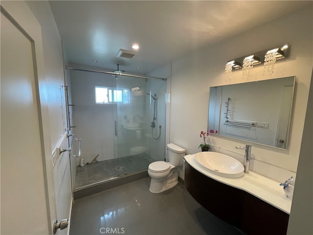 bathroom with vanity, a shower stall, toilet, and visible vents