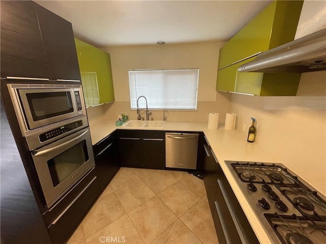 kitchen featuring a sink, stainless steel appliances, range hood, and light countertops