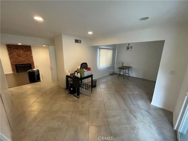 interior space featuring recessed lighting, light tile patterned flooring, a fireplace, and visible vents