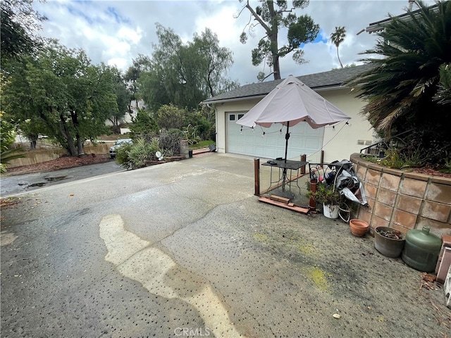 exterior space featuring concrete driveway and an outbuilding