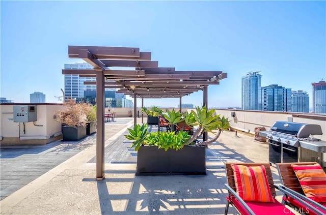 view of patio / terrace with a city view, a pergola, and grilling area