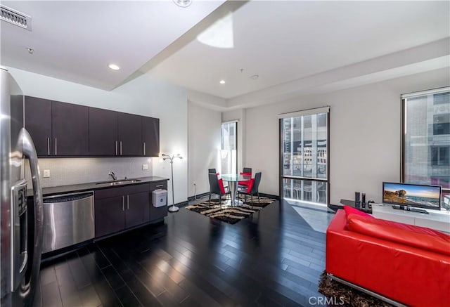 kitchen featuring dark wood finished floors, visible vents, backsplash, and appliances with stainless steel finishes