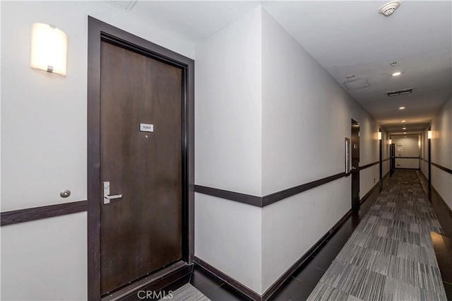 hallway featuring recessed lighting, baseboards, and visible vents