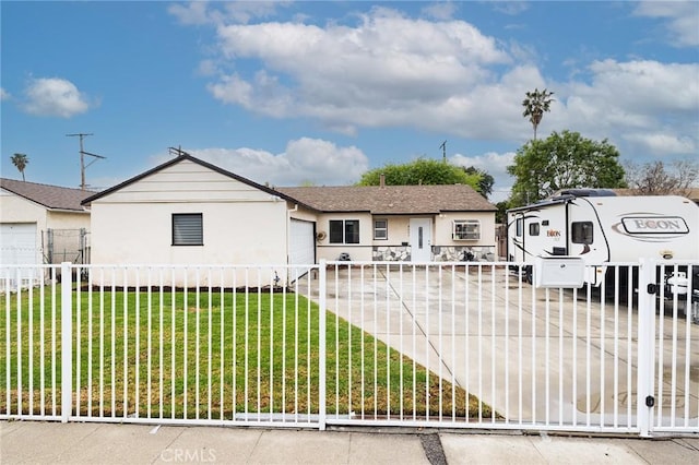 view of front of house with a front lawn, a garage, a fenced front yard, and stucco siding