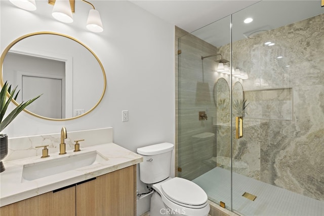 full bathroom with vanity, toilet, and a shower stall