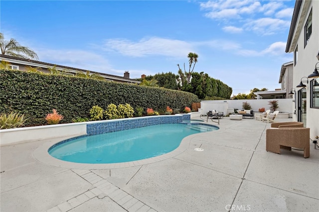 view of swimming pool featuring a patio, a fenced backyard, a fenced in pool, and an outdoor hangout area