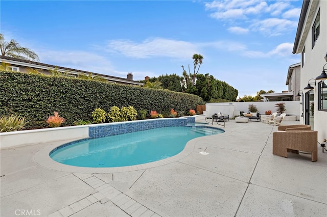view of swimming pool featuring a fenced backyard, a patio, and a fenced in pool