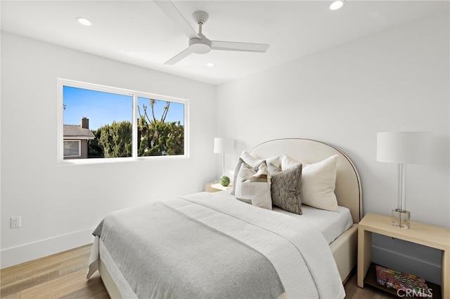 bedroom featuring recessed lighting, wood finished floors, baseboards, and ceiling fan