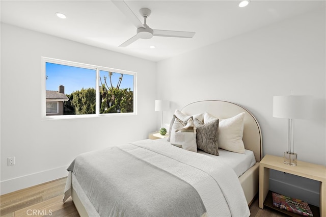 bedroom featuring wood finished floors, recessed lighting, a ceiling fan, and baseboards