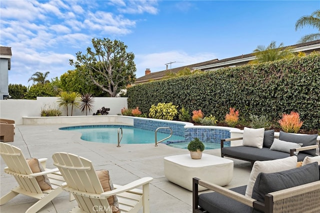view of swimming pool with outdoor lounge area, a fenced backyard, a fenced in pool, and a patio area