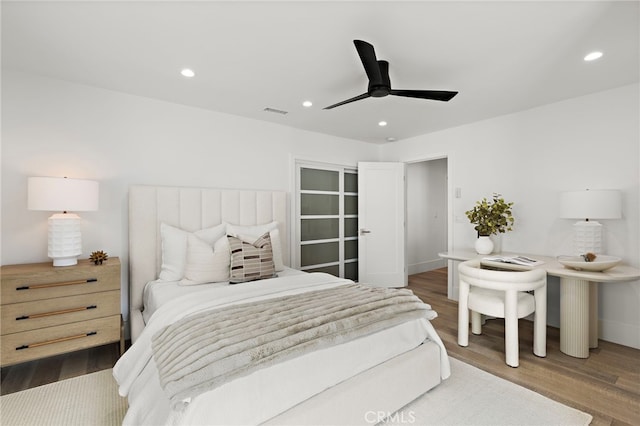 bedroom featuring visible vents, wood finished floors, recessed lighting, baseboards, and ceiling fan