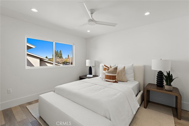 bedroom featuring baseboards, recessed lighting, and wood finished floors
