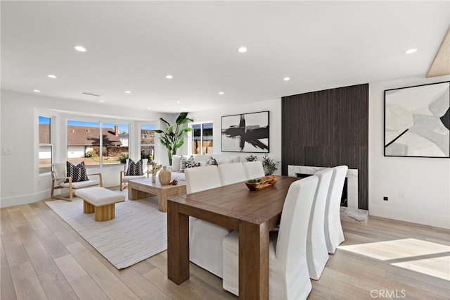dining space featuring light wood finished floors, recessed lighting, and baseboards
