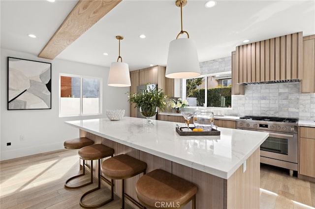 kitchen featuring recessed lighting, stainless steel range with gas stovetop, and a wealth of natural light