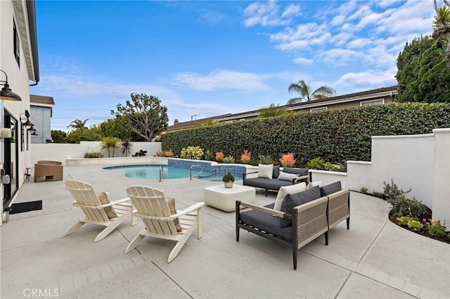 view of swimming pool with outdoor lounge area, a fenced backyard, a fenced in pool, and a patio area
