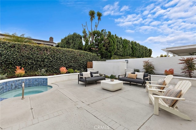 view of patio with an outdoor living space, an in ground hot tub, and a fenced backyard