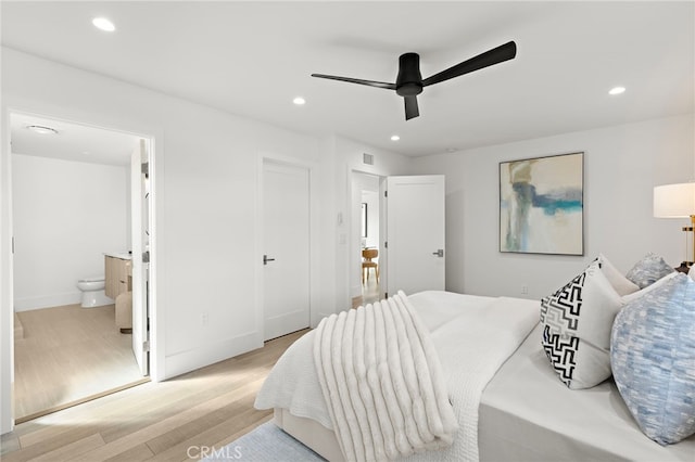 bedroom featuring ensuite bath, recessed lighting, light wood-style floors, baseboards, and ceiling fan