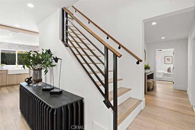 staircase with recessed lighting and wood-type flooring