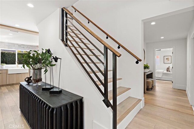 stairs with hardwood / wood-style floors and recessed lighting